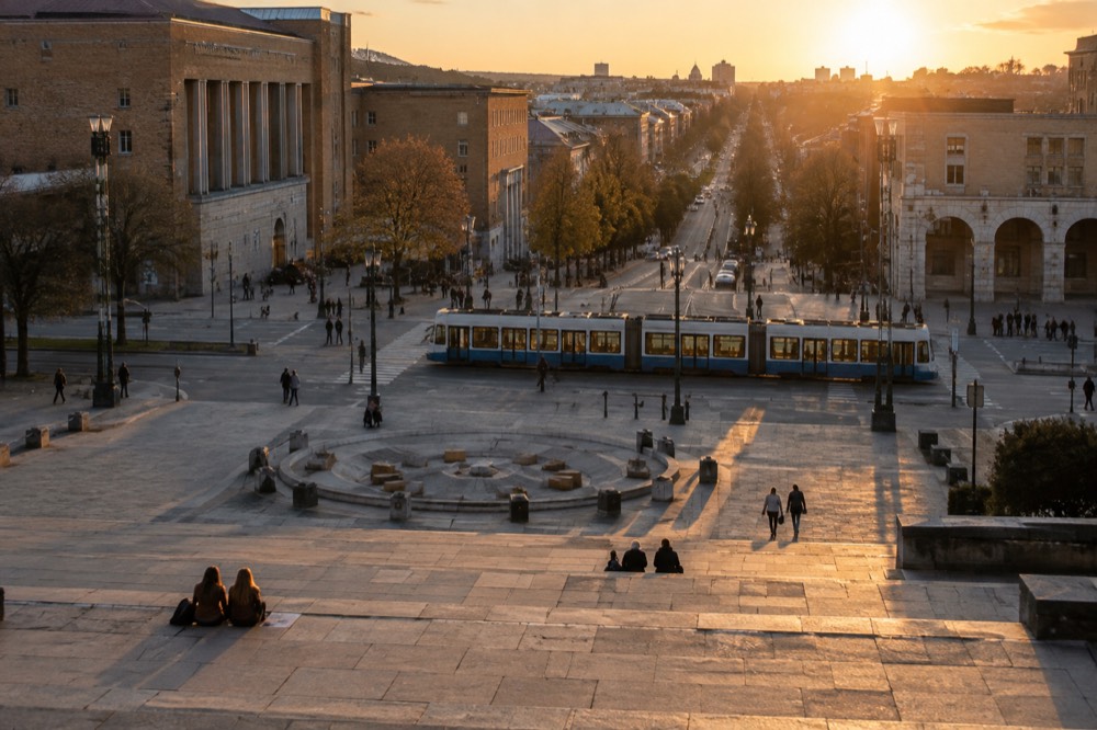A tram passing along a Gothenburg street with the Avenyn boulevard in the background