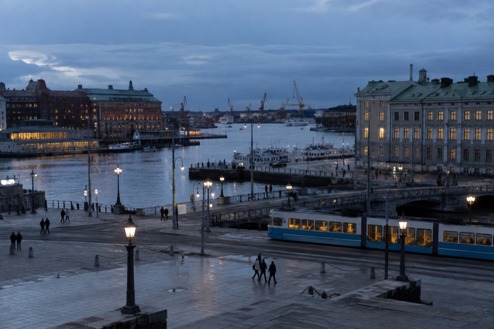 View over Gothenburg harbour with red brick buildings, moat water and a passing tram