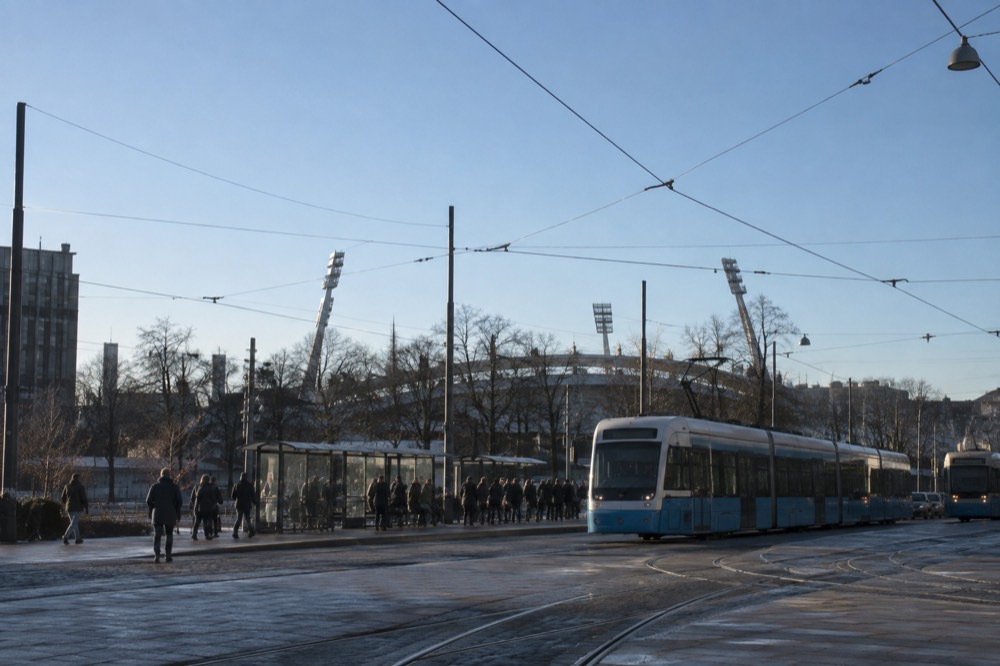 Trams passing at Korsvägen interchange in Gothenburg with the stadium district in the background