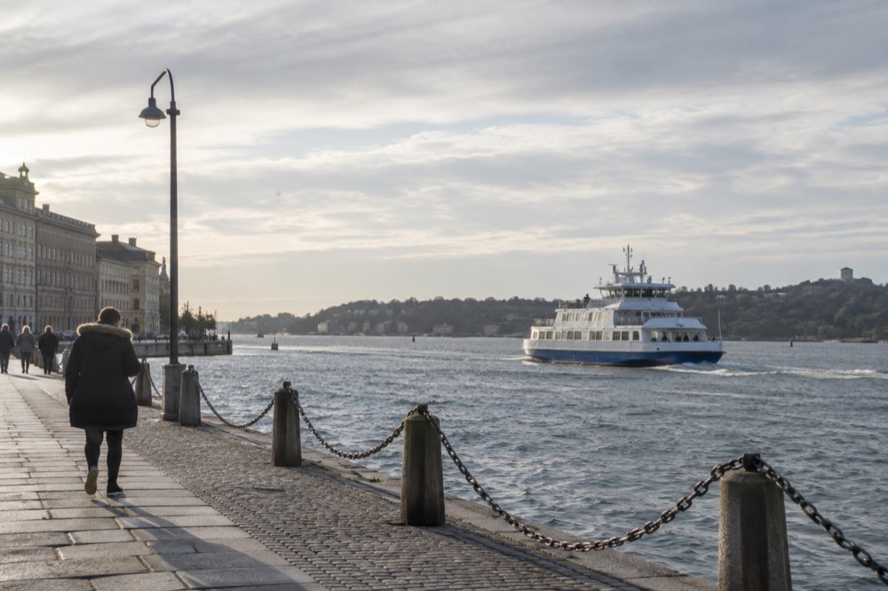 A passenger ferry crossing open water towards the green islands of the Gothenburg southern archipelago