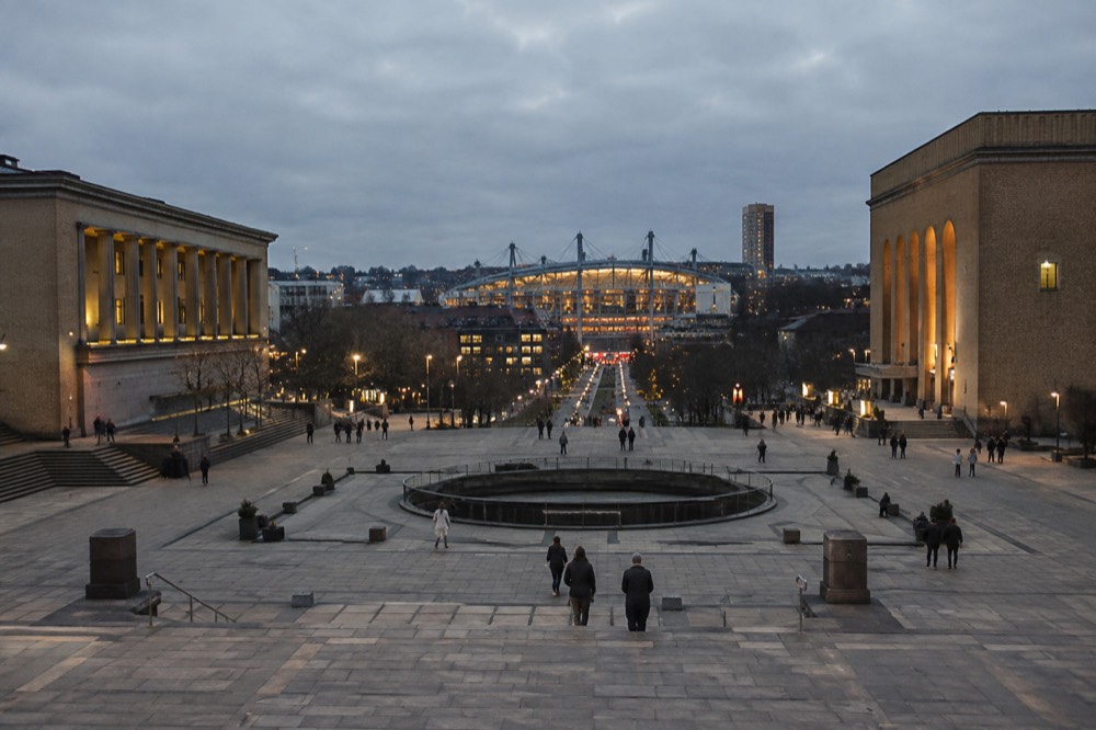 The stadium district in Gothenburg under evening light with the arena and nearby buildings lit up