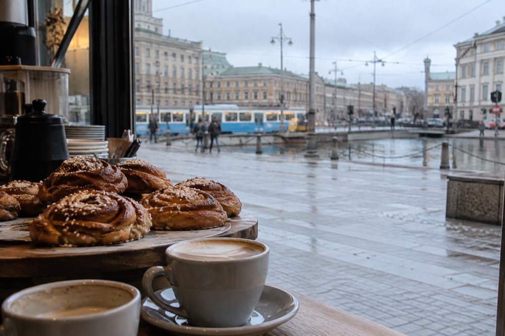 Cinnamon buns and coffee cups on a café counter in Gothenburg