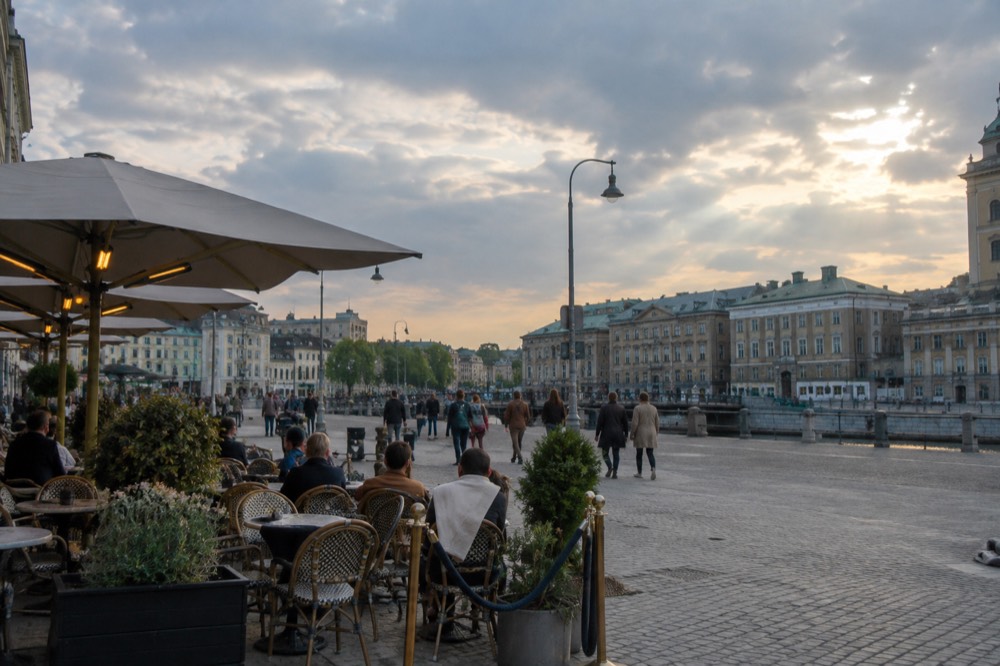 Evening light over restaurant tables along a street in central Gothenburg