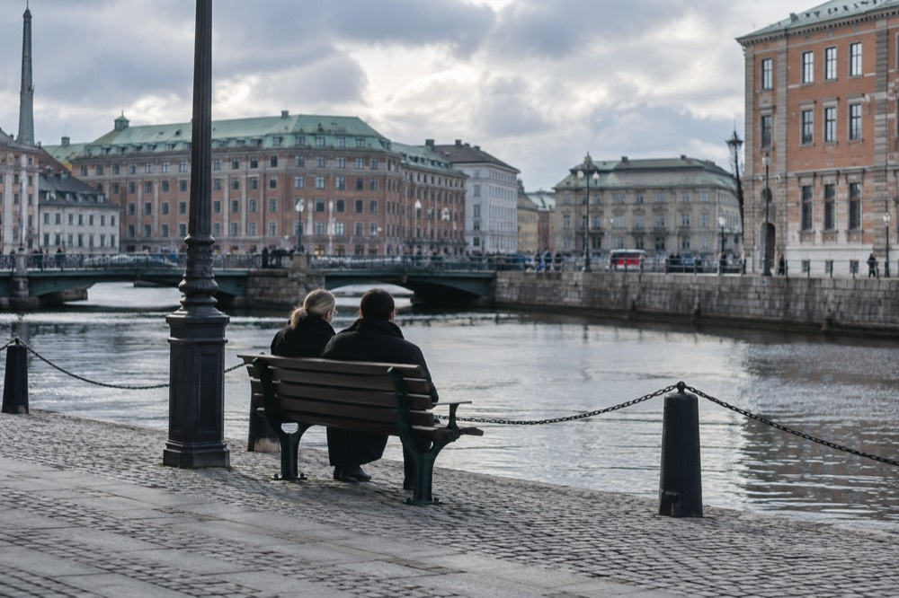 Red brick buildings and a canal in central Gothenburg under a grey Nordic sky