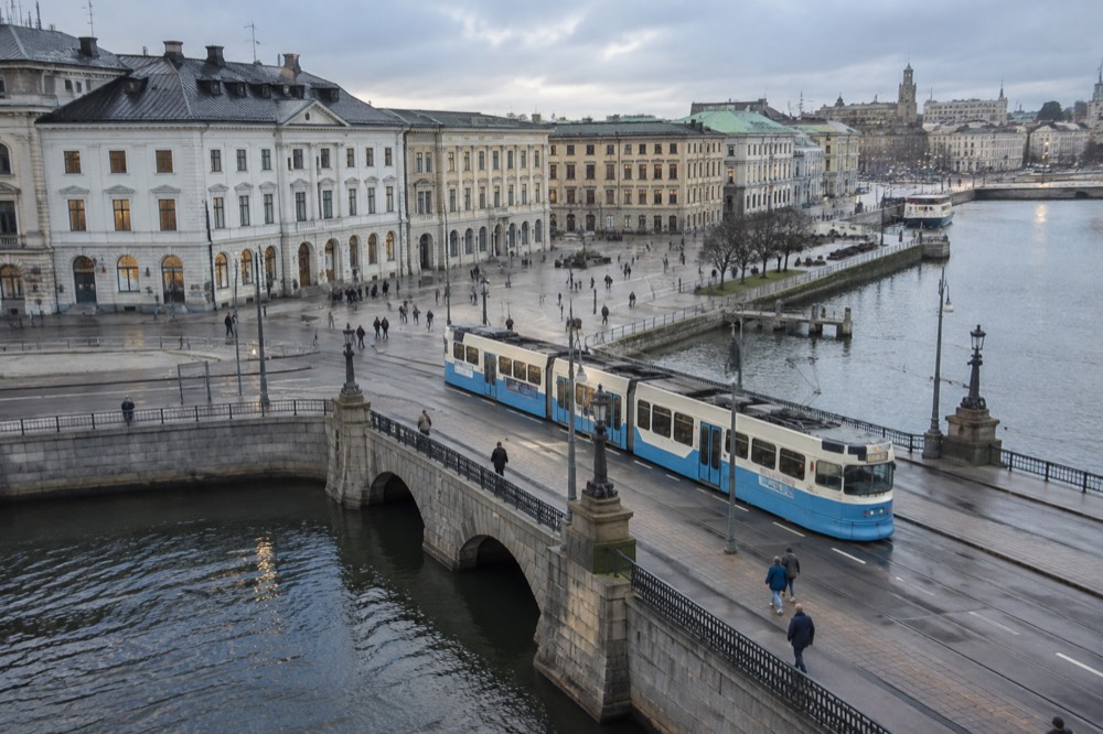 A Gothenburg tram crossing a stone bridge over a canal in the city centre