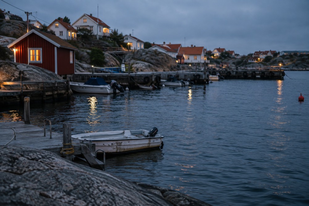 White wooden houses with red roofs clustered around a small harbour on Styrsö island