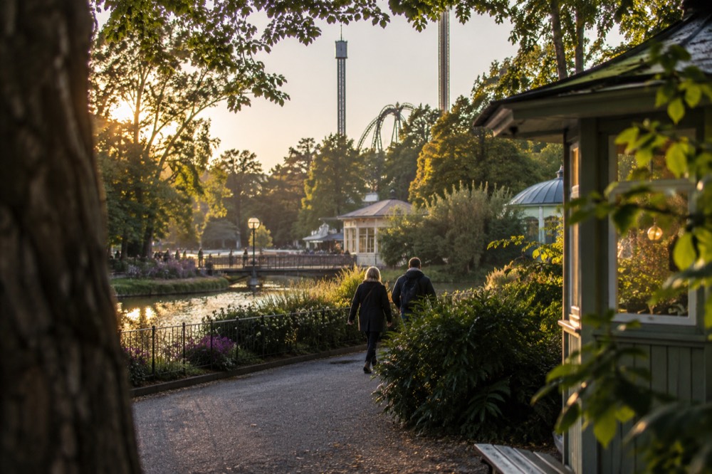 Liseberg amusement park lit up at dusk with a ferris wheel against the sky