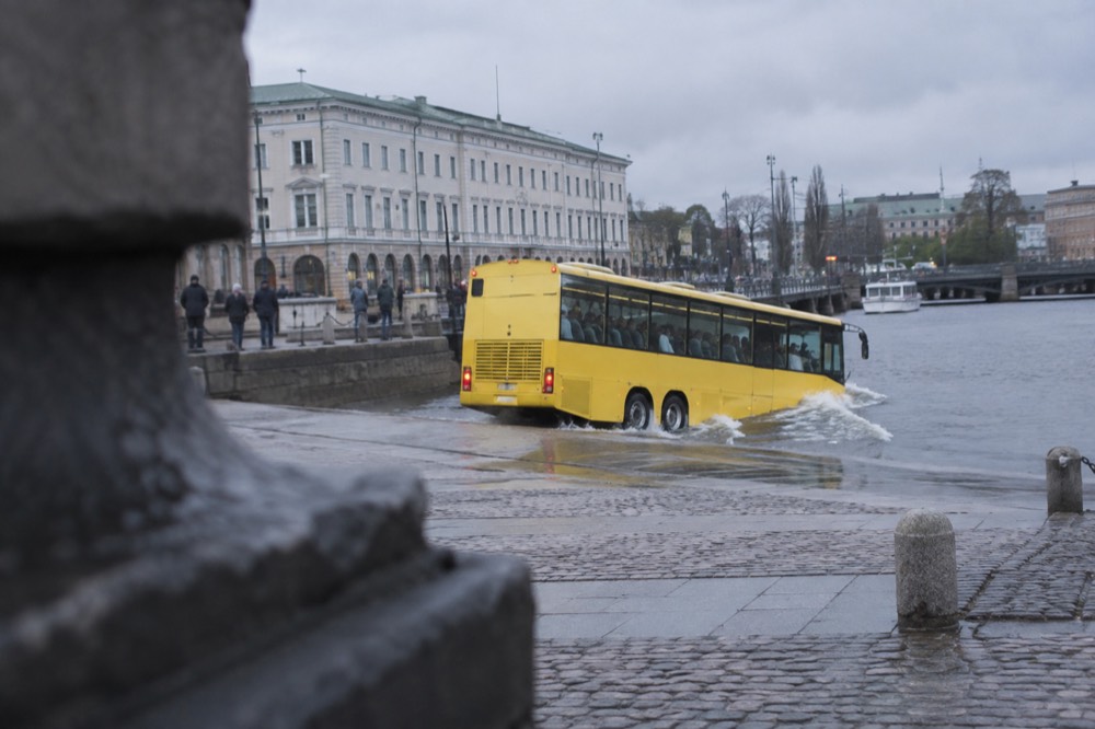 Amphibious sightseeing bus driving into the water in Gothenburg harbour in the rain