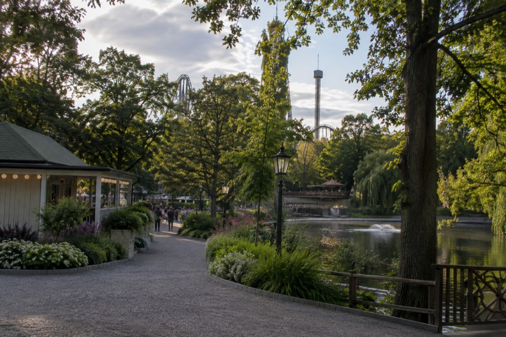 Amusement park rides and planted gardens at Liseberg in summer