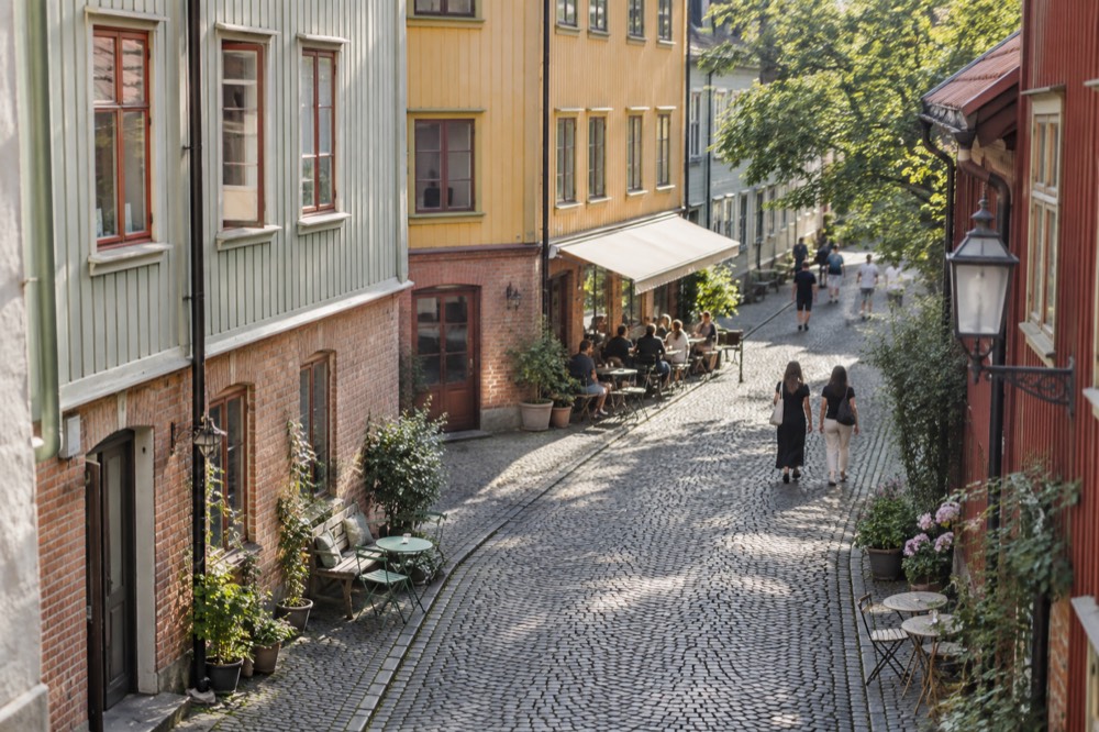 Cobbled street in Haga with painted wooden houses and cafés